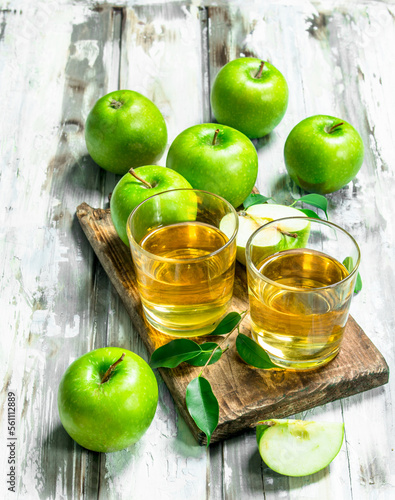 Apple juice in a glass Cup on a wooden Board.