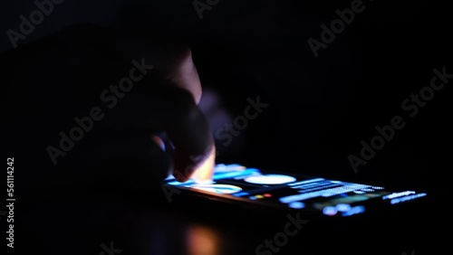 Close up of man finger using and touching on smartphone screen with reflection and black background in the darkness. Social network surfing, instagram or facebook or tiktok