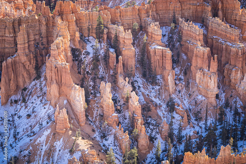 Winter scenery from Bryce Canyon National Park with brilliantly colored orange cliffs and a touch of snow in Utah.