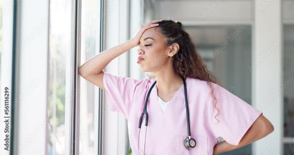 Doctor, woman and stress by window with headache, burnout or sad in hospital workplace with hand on head. Black woman, healthcare medic and mental health problem at clinic job with anxiety in Atlanta Doctor, woman and stress by window with headache, burnout or sad in hospital workplace with hand on head. Black woman, healthcare medic and mental health problem at clinic job with anxiety in Atlanta