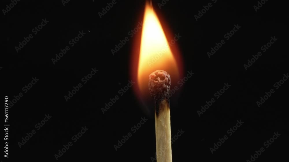 Closeup Match burning and combusting on black background. Match lights up in slow motion arbitrarily from burning air or temperature. No traces of arson. Spontaneous combustion of sulfur . Closeup Match burning and combusting on black background. Match lights up in slow motion arbitrarily from burning air or temperature. No traces of arson. Spontaneous combustion of sulfur .
