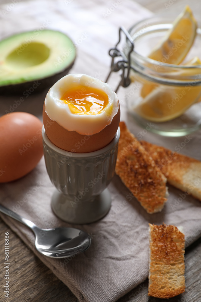 Fototapeta premium Soft boiled egg served for breakfast on wooden table