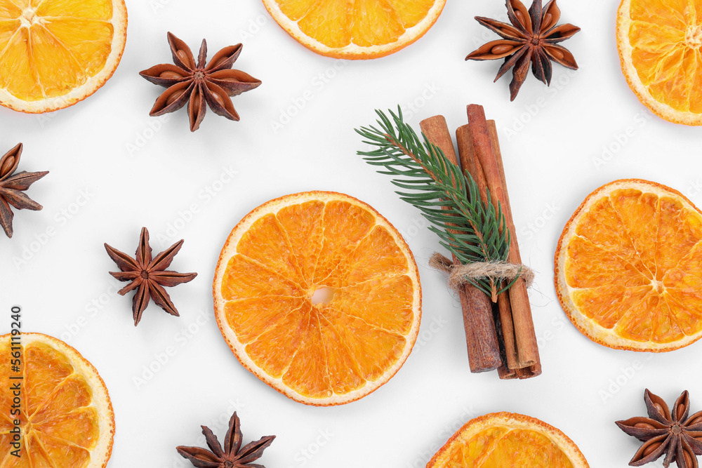 Flat lay composition with dry orange slices, anise stars and cinnamon sticks on white background Flat lay composition with dry orange slices, anise stars and cinnamon sticks on white background