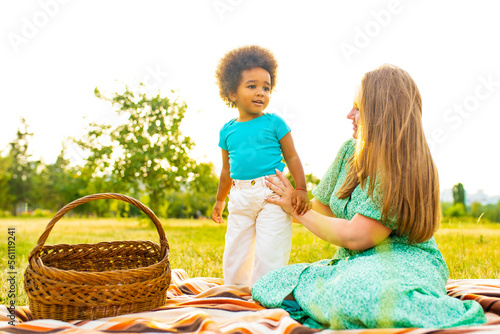 happy mother and cute adorable little girl at pinic in summer park photo