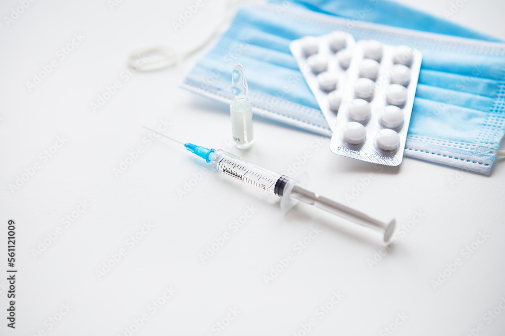 Preparation for vaccination against covid-19. Syringe, vaccine, pills, medical mask. Preparation for vaccination against covid-19. Syringe, vaccine, pills, medical mask.