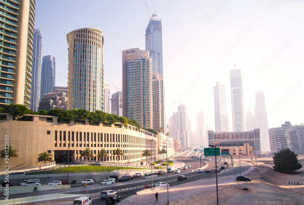 Dubai, UAE 2022. City road view with cars at sunset