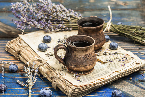 The concept of rustic style tea. Lavender flowers and blueberries. Vintage book