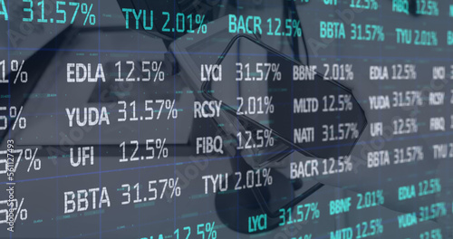 Digital image of stock market data processing against smartphone on table