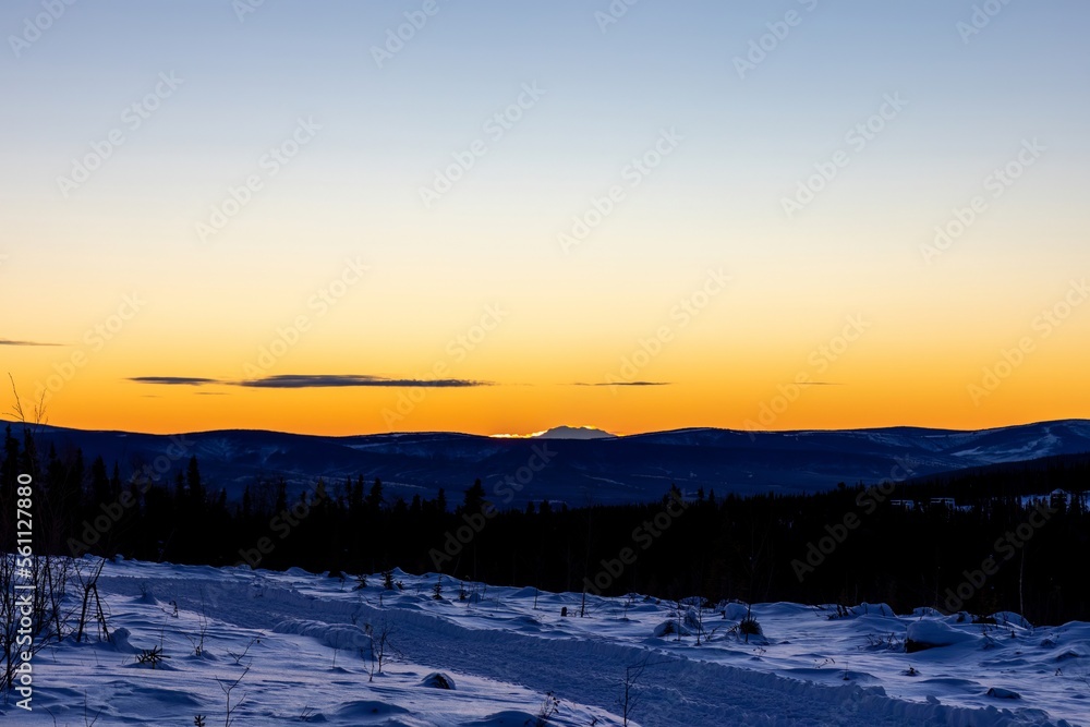 Serene Sunset winter landscape in Fairbanks Alaska with view of the peak of mount Denali in horizon