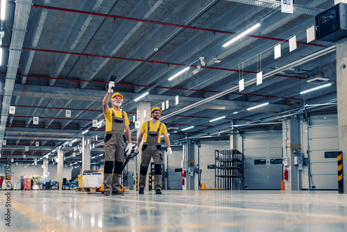 Warehouse workers pulling a pallet truck