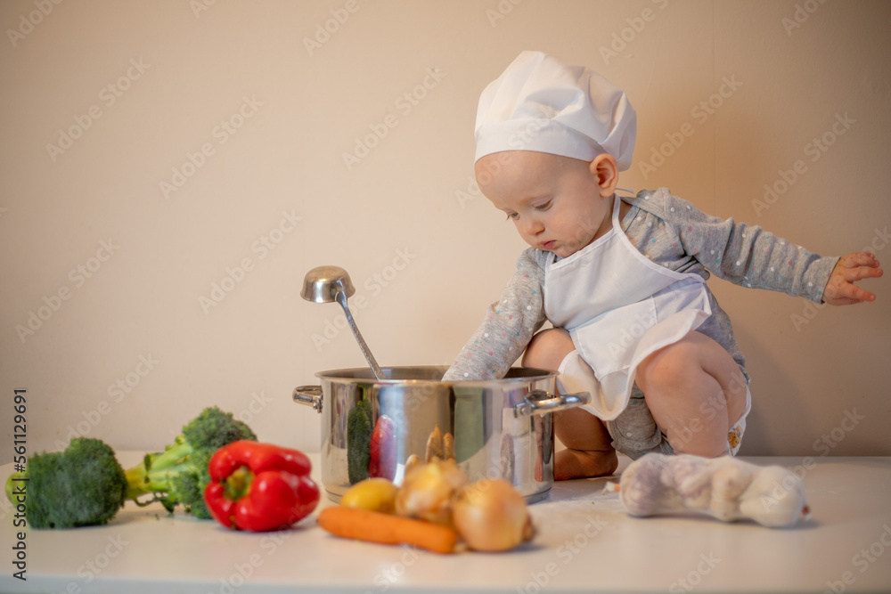 Little female chef preparing vegetable soup in kitchen. Little female chef preparing vegetable soup in kitchen.