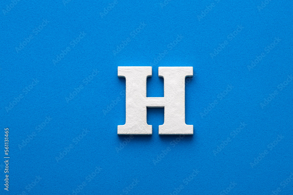 Letter H uppercase - White wood font on blue foamy background Letter H uppercase - White wood font on blue foamy background