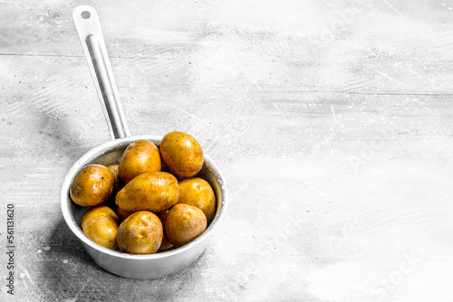 Potatoes in the ladle. photo