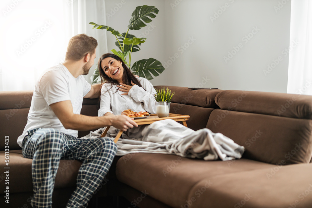 Young couple having breakfast in the living room Young couple having breakfast in the living room
