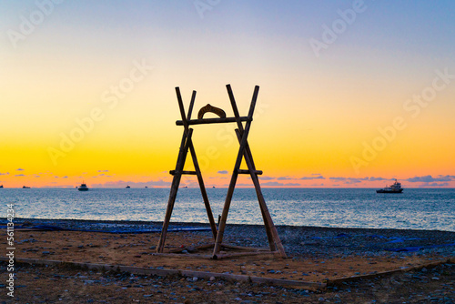 Wooden swing against the background of the sea