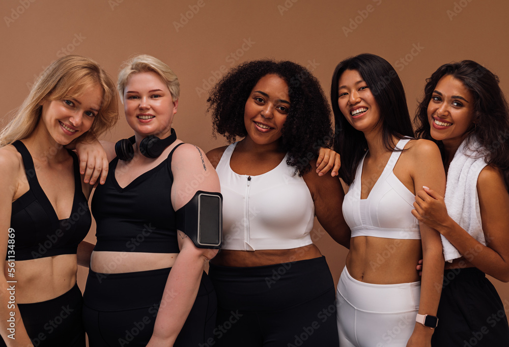 Five smiling women with different body types and skin color posing ...