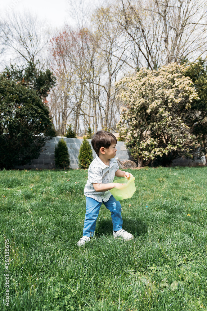 Little boy searching for eggs on Easter Little boy searching for eggs on Easter