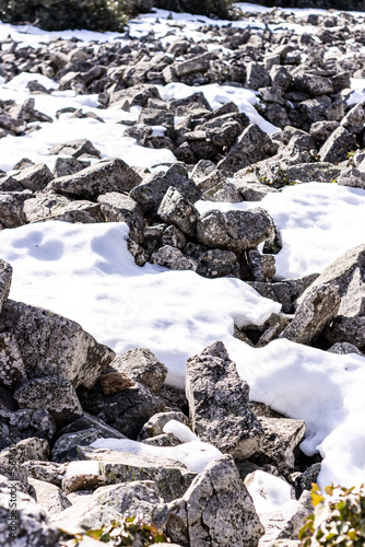 Abstract winter texture background. Stones, snow and ice in nature pattern. Close up image