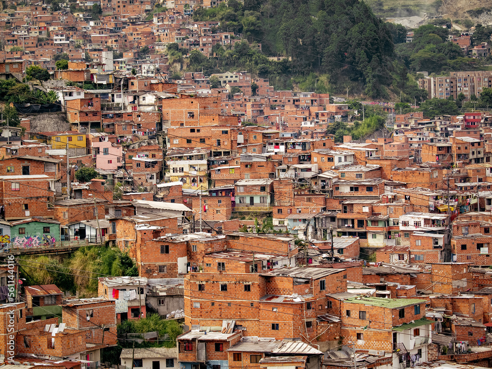 The comuna 13 neighborhood in Medellin, Colombia has transformed from a former ghetto to a well-developed area, with stacked houses as a unique feature.