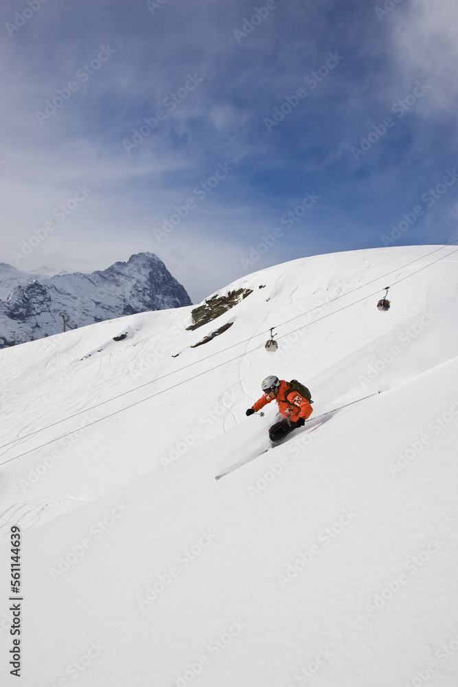 A young man skis off-piste in Grindelwald, Switzerland. A young man skis off-piste in Grindelwald, Switzerland.