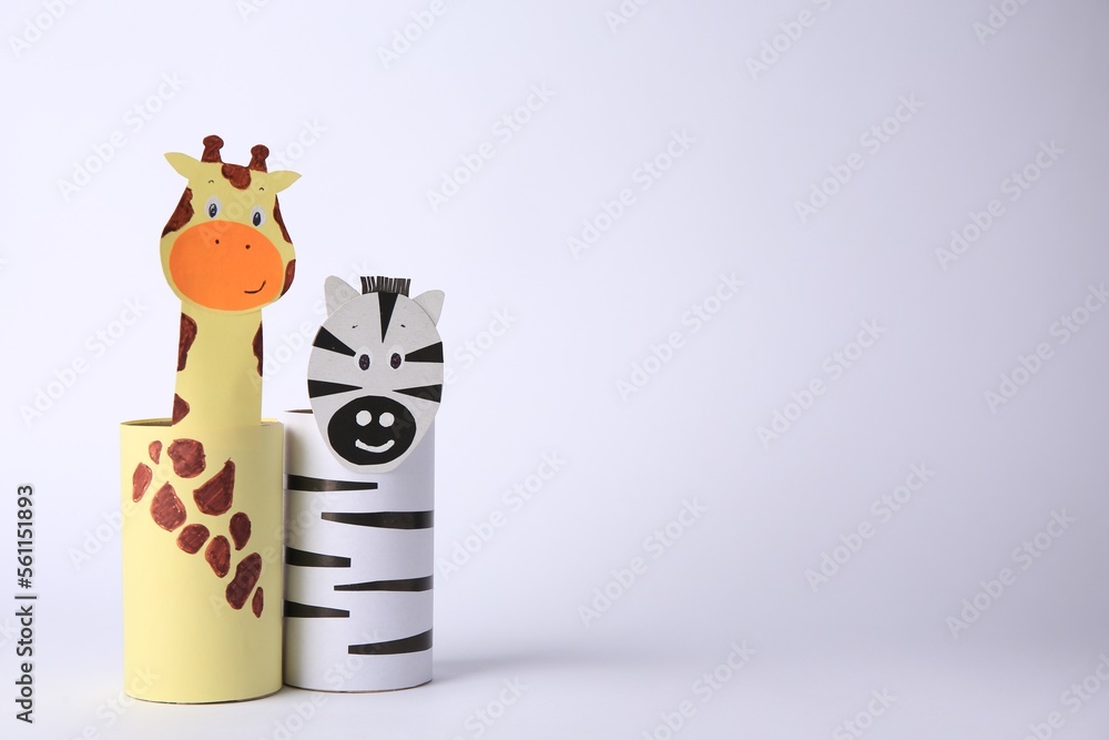 Toy giraffe and zebra made from toilet paper hubs on white background, space for text. Children's handmade ideas Toy giraffe and zebra made from toilet paper hubs on white background, space for text. Children's handmade ideas