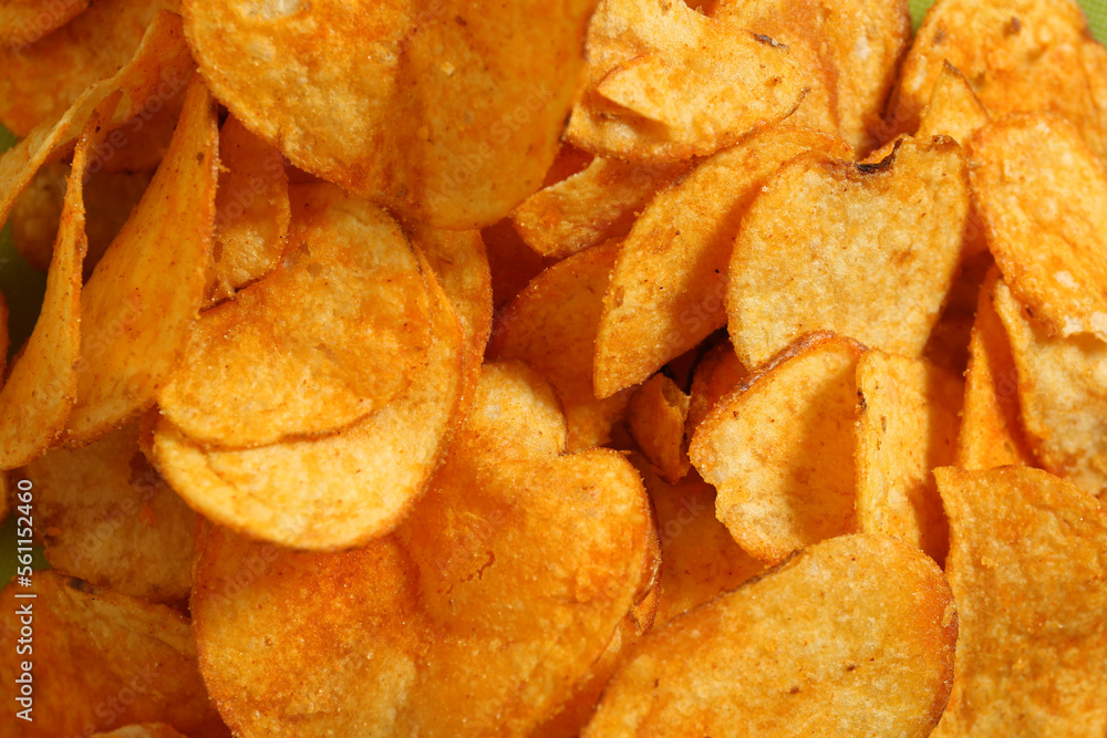 Crispy potato chips as background, closeup view Crispy potato chips as background, closeup view