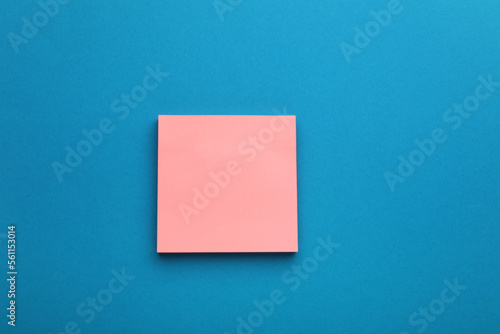 Paper note on blue background, top view