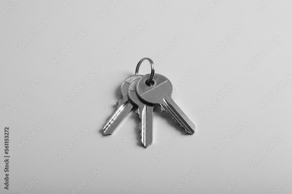 Keys on light grey background, above view. Real estate agent services Keys on light grey background, above view. Real estate agent services