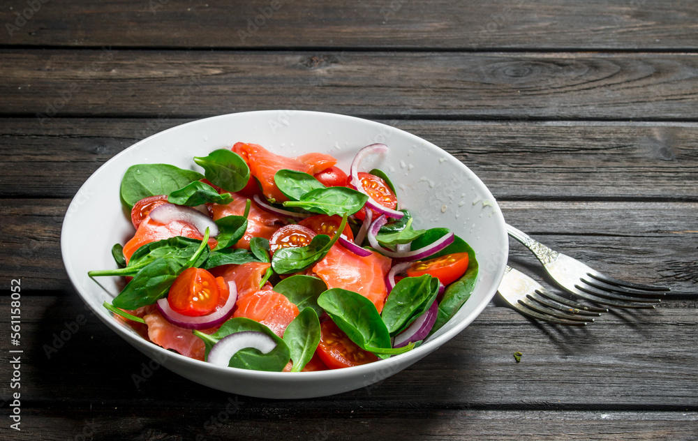 Fish salad. Salad with slices of salmon, tomatoes and spinach with lime juice. Fish salad. Salad with slices of salmon, tomatoes and spinach with lime juice.