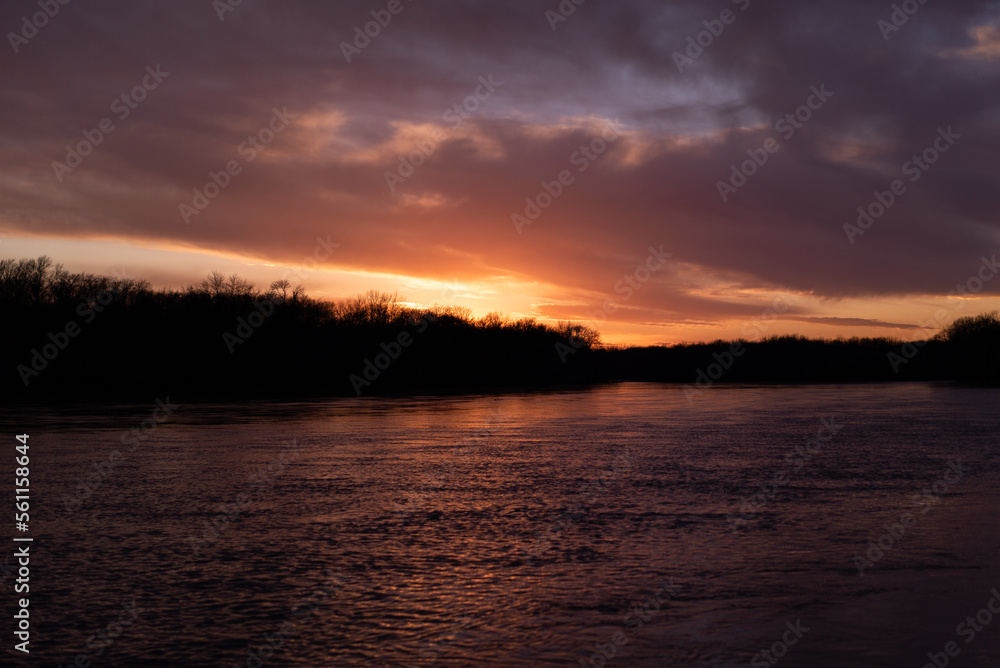 Colorful sunrise on large river