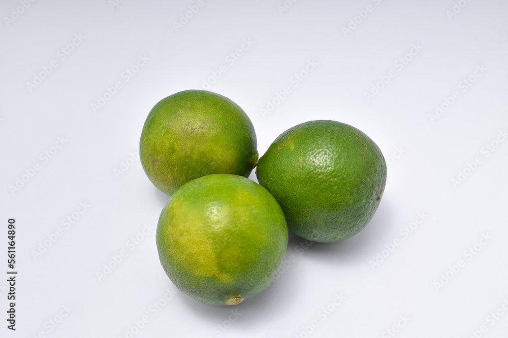 three limes isolated on a white background. three limes isolated on a white background.