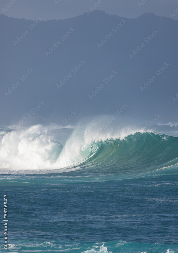 Big breaking Ocean wave on a sandy beach on the north shore of Oahu Hawaii Big breaking Ocean wave on a sandy beach on the north shore of Oahu Hawaii