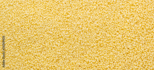 Couscous, dry wheat grain, food background texture, top view horizontal banner photo