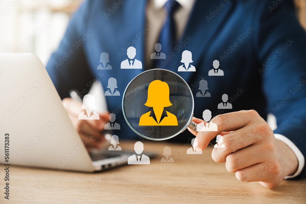 HRM human resource management concept, executive holding a magnifying glass to search for effective personnel, human resource management in the organization, human development and recruitment. HRM human resource management concept, executive holding a magnifying glass to search for effective personnel, human resource management in the organization, human development and recruitment.