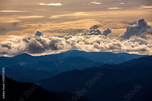 beautiful rainforest mountains landscape with big white rainy clouds at sunset © nutt