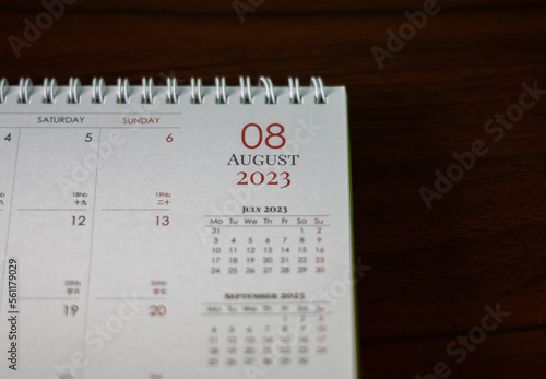 Top view shot of a 2023 calendar, "August page". Selective focus shot of a calendar, focused on "08, August, 2023".