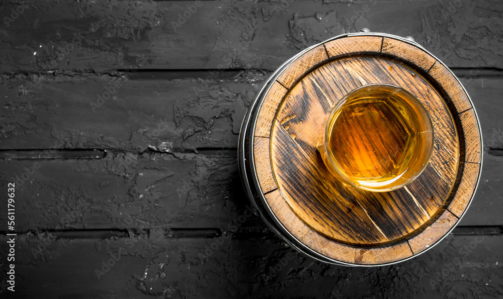 Whiskey in a glass on a barrel. Whiskey in a glass on a barrel.