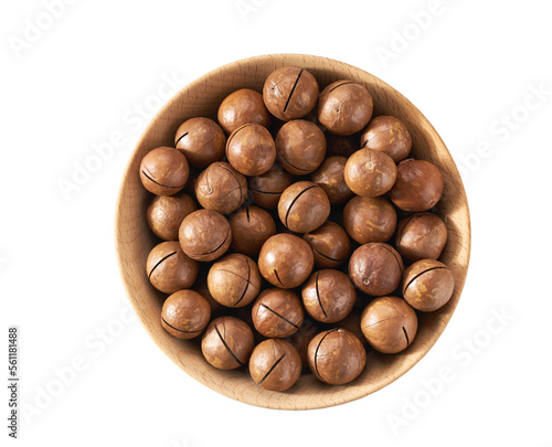 Macadamia in wooden bowl isolated on white background, top view.