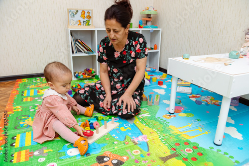 Grandmother and granddaughter playing with wooden sorters