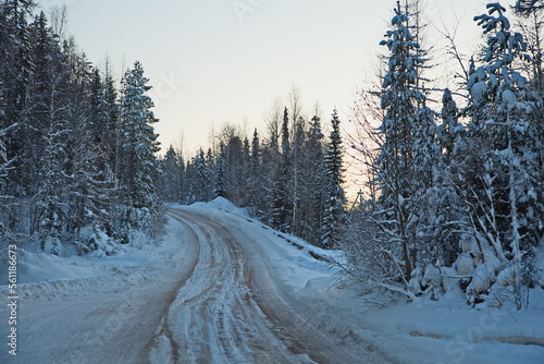 Winter road in the evening in the north of Russia.