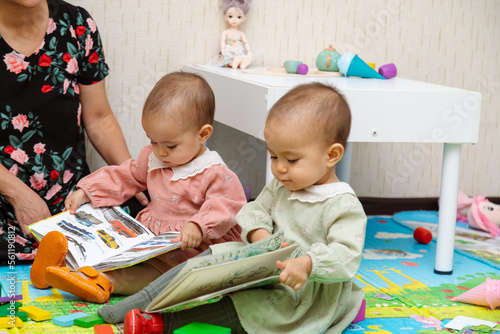 Grandmother and toddler reading books at home