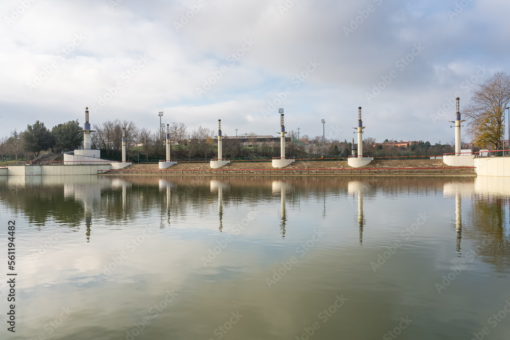 Public park with a large lake that reflects in the water the decorative architecture of the park, Tres Cantos, Madrid.