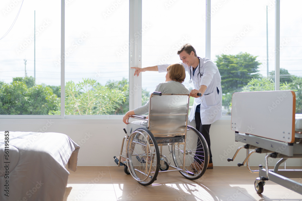 Portrait of caucasian doctor check up body of disabled old senior elderly patient using wheelchair try to walk in hospital in medical and healthcare treatment at nursing home. People lifestyle Portrait of caucasian doctor check up body of disabled old senior elderly patient using wheelchair try to walk in hospital in medical and healthcare treatment at nursing home. People lifestyle