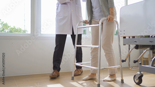 Portrait of caucasian doctor check up body of sick old senior elderly patient using walker, walking in hospital in medical and healthcare treatment at nursing home or clinic. People lifestyle