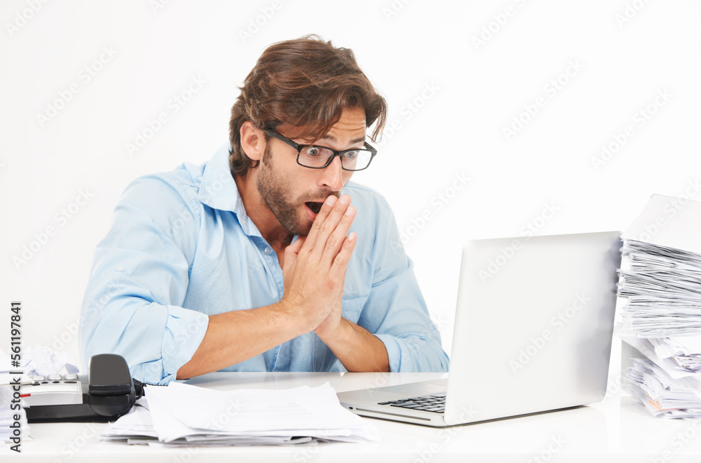 Laptop, paperwork and shocked businessman working on a project with a deadline in a studio. Shock, surprise and professional male employee with a computer and corporate documents by white background. Laptop, paperwork and shocked businessman working on a project with a deadline in a studio. Shock, surprise and professional male employee with a computer and corporate documents by white background.