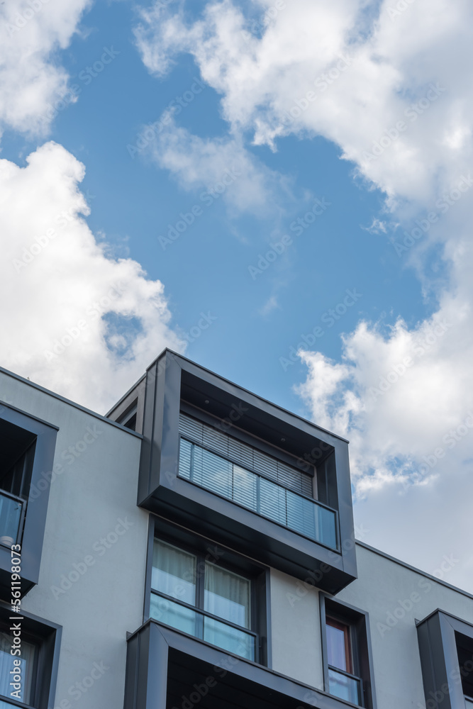 Gray french balcony under a blue cloud window Gray french balcony under a blue cloud window