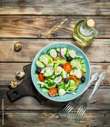 Vegetable salad. Tomato, cucumber and quail egg salad with olive oil and Basil.