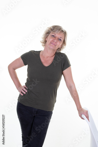 cheerful senior sixties woman standing hair blonde near seat on white background