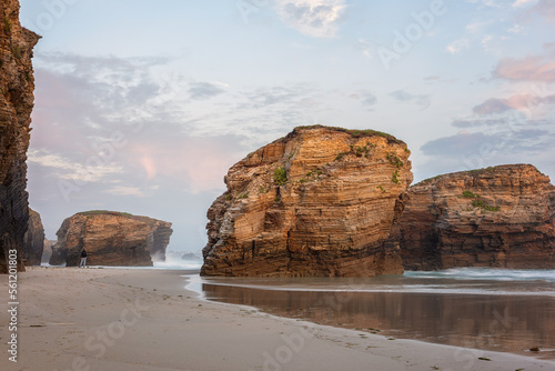 Cathedrals beach (Playa de las Catedrales) or Praia de Augas Santas at sunset, amazing landscape with rocks on the Atlantic coast and colored sky, Ribadeo, Galicia, Spain. Outdoor travel background photo