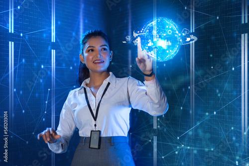 Female Technician touching on digital globe screen, future technology concept